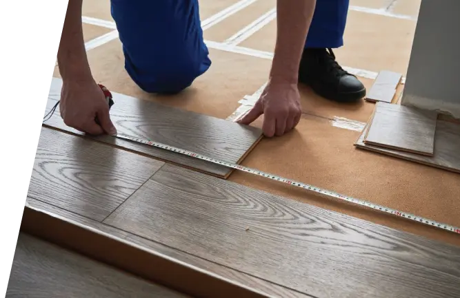 Carpenter measuring for hardwood flooring installation