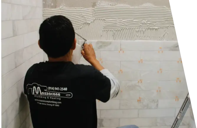 Worker adding new shower tile in bathroom